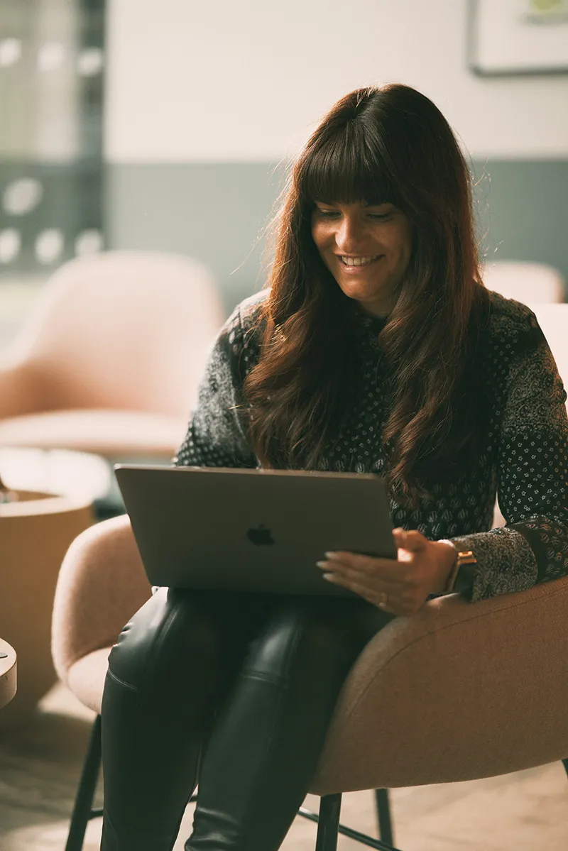 Smiling woman working on a laptop